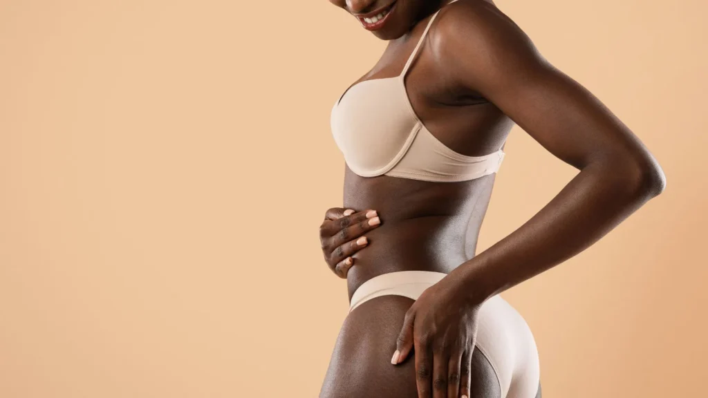 Black woman showing non surgical sculpted waist and abdomen representing PHYSIQ non-surgical body sculpting cockeysville, MD.