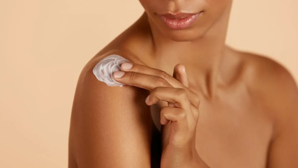 Skin health after UF exposure with woman applying moisturizer to help in healing