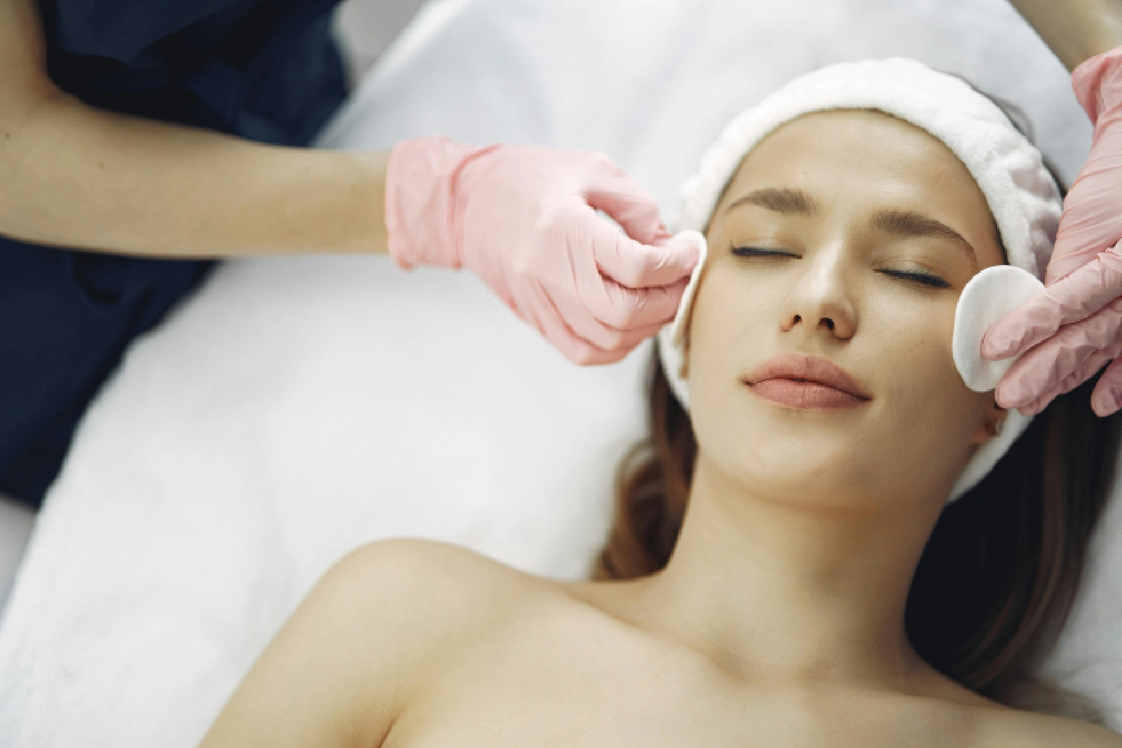Woman receiving a facial treatment from a professional.