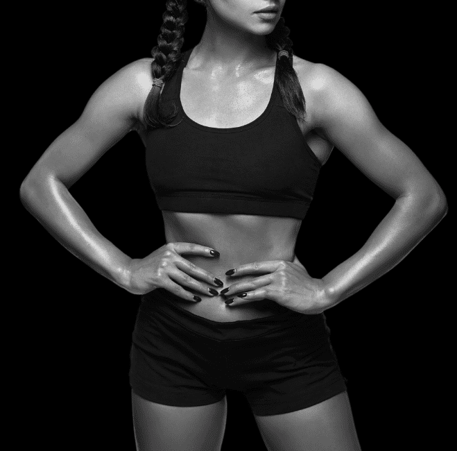 Fit client in athletic wear showing a toned abdomen and arms from body sculpting treatments provided by Body Scientific Aesthetics, in Timonium, MD.