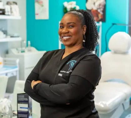 Smiling dental professional with arms crossed in clinic