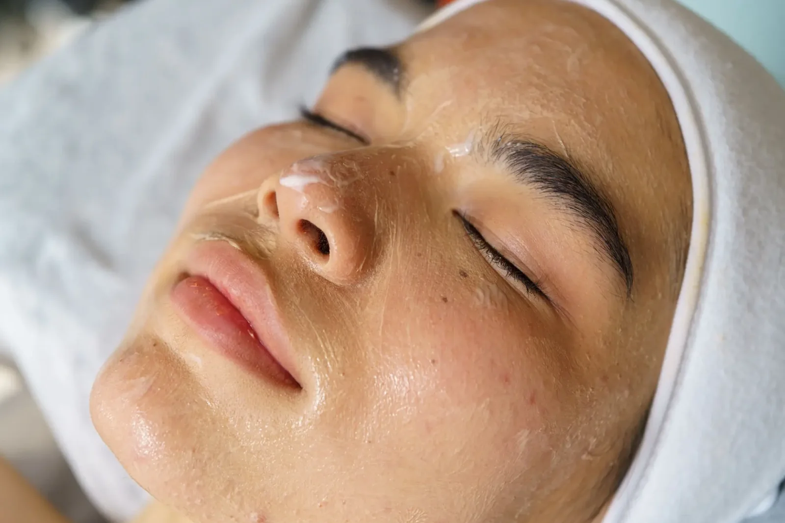 Close-up of a woman receiving a medical-grade facial treatment with a soothing mask at Body Scientific Aesthetics in Timonium, Maryland.
