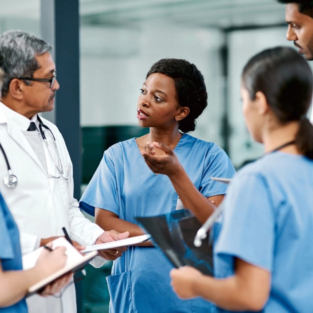 Medical team discussing patient care in hospital.