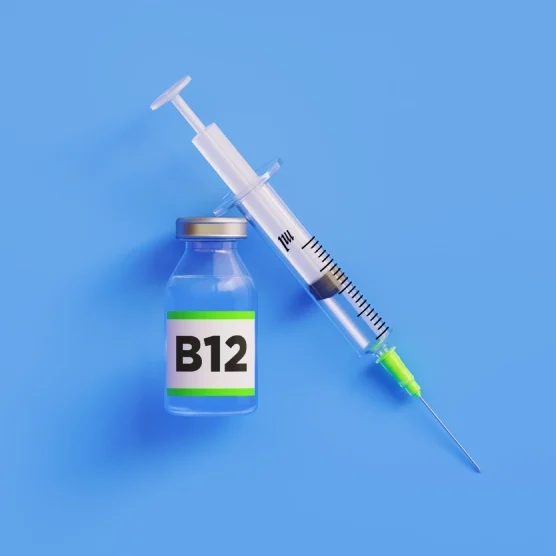 A syringe and vial labeled B12 against a blue background.