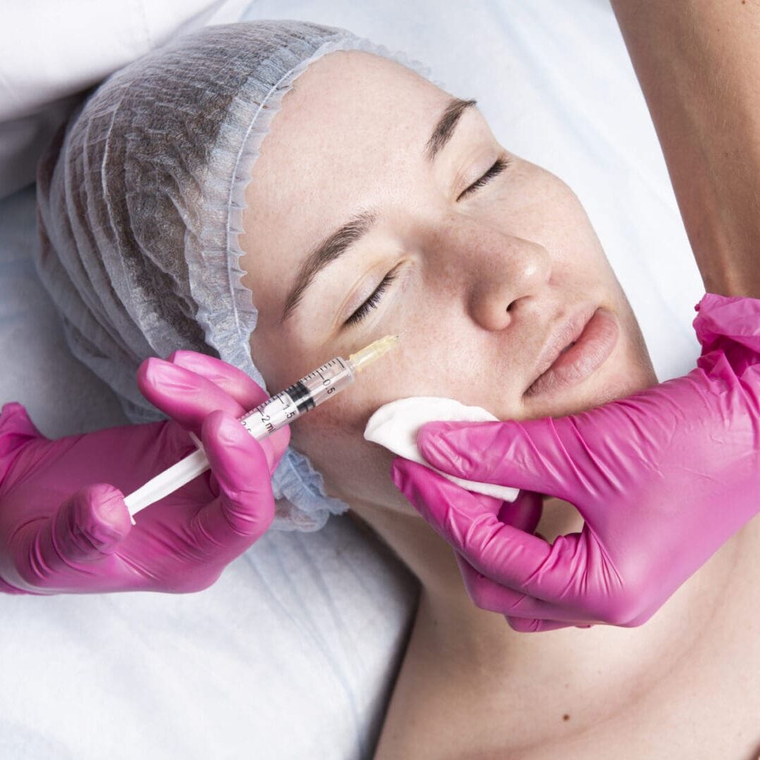 Woman receiving a facial injection treatment at a clinic.