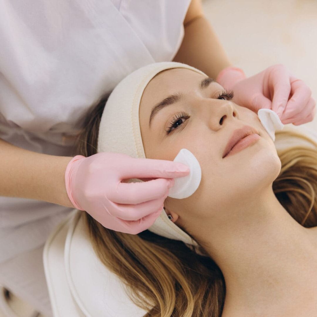 Woman receiving a facial treatment at a spa.