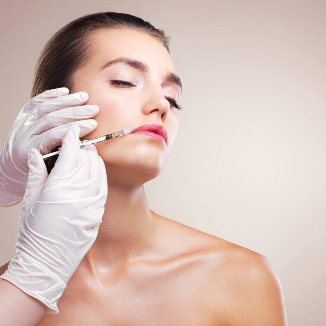 A woman receives a cosmetic facial injection.