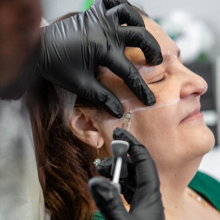 A woman receiving a cosmetic facial injection.