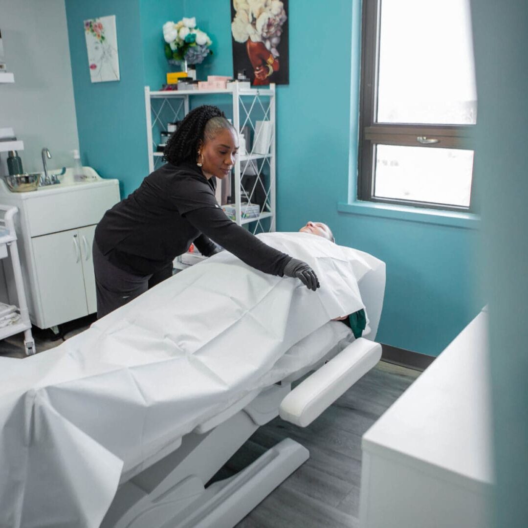 A healthcare professional attending to a patient on a medical examination table.